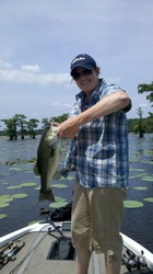 man on caddo lake holding a bass